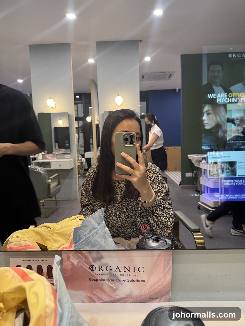 Woman taking a mirror selfie in a salon