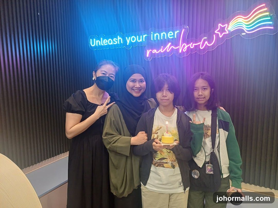 People posing in front of neon sign