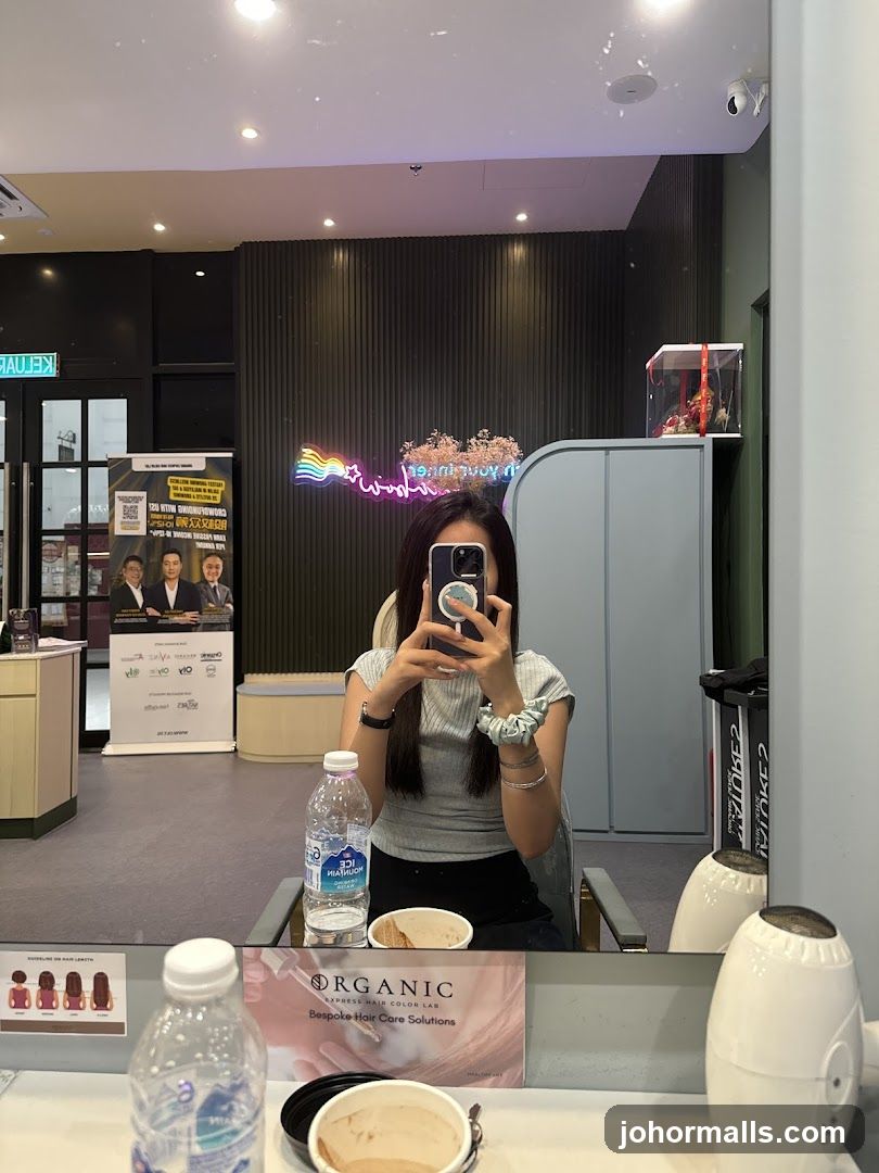 Woman taking a mirror selfie in a salon