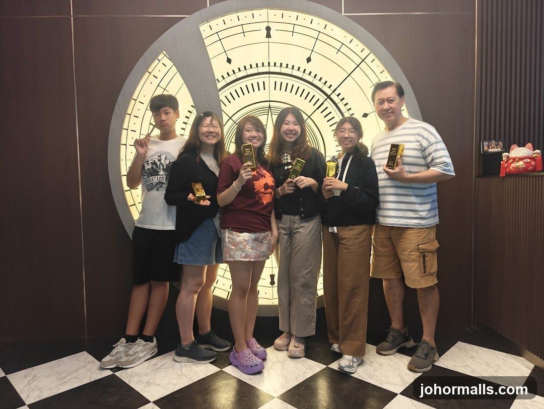 Group posing with gold bars