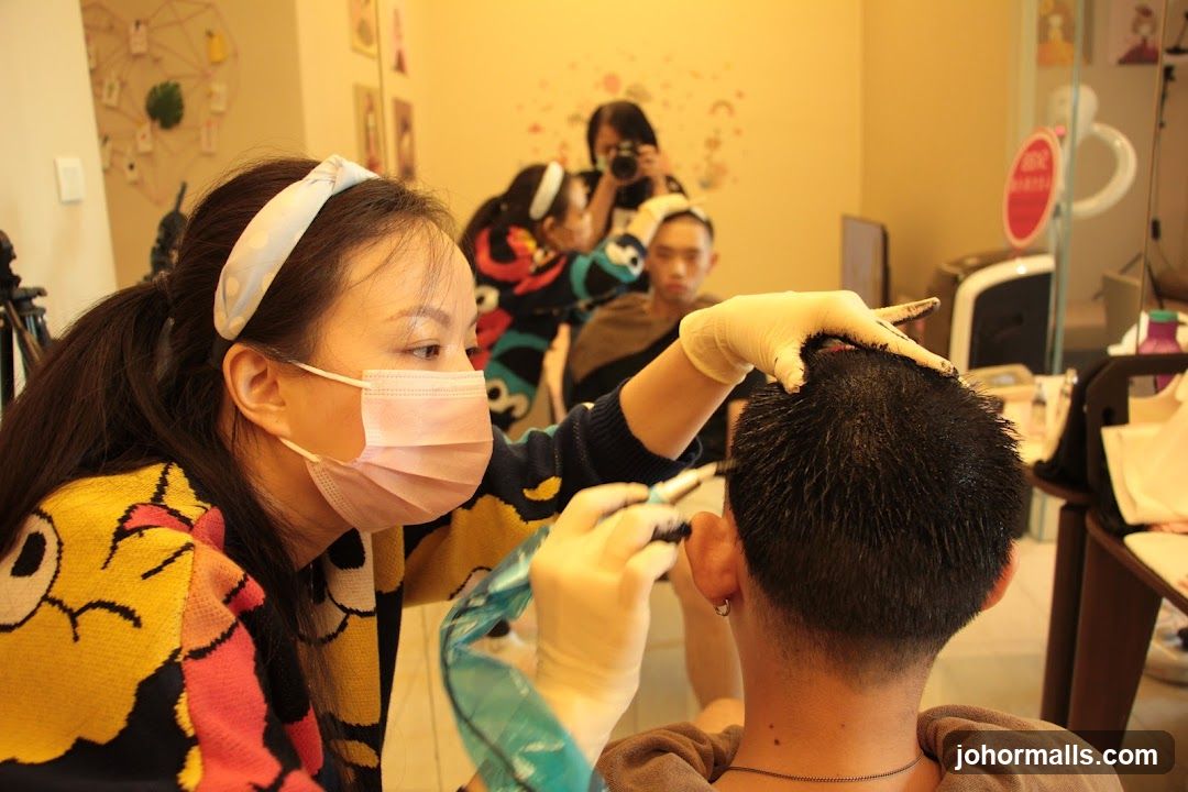 Hairdresser applying dye to client's hair