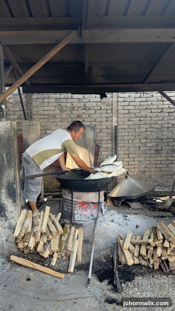 Man cooking fish over open fire