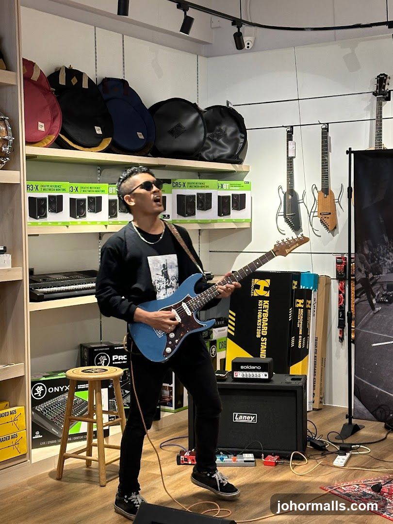 Man playing guitar in a music store