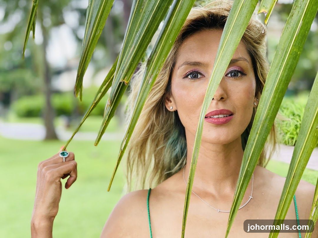 Woman behind palm leaves
