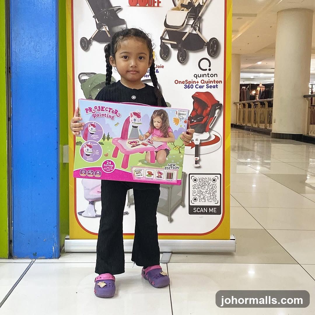 Child Holding a Toy Projector Painting Set