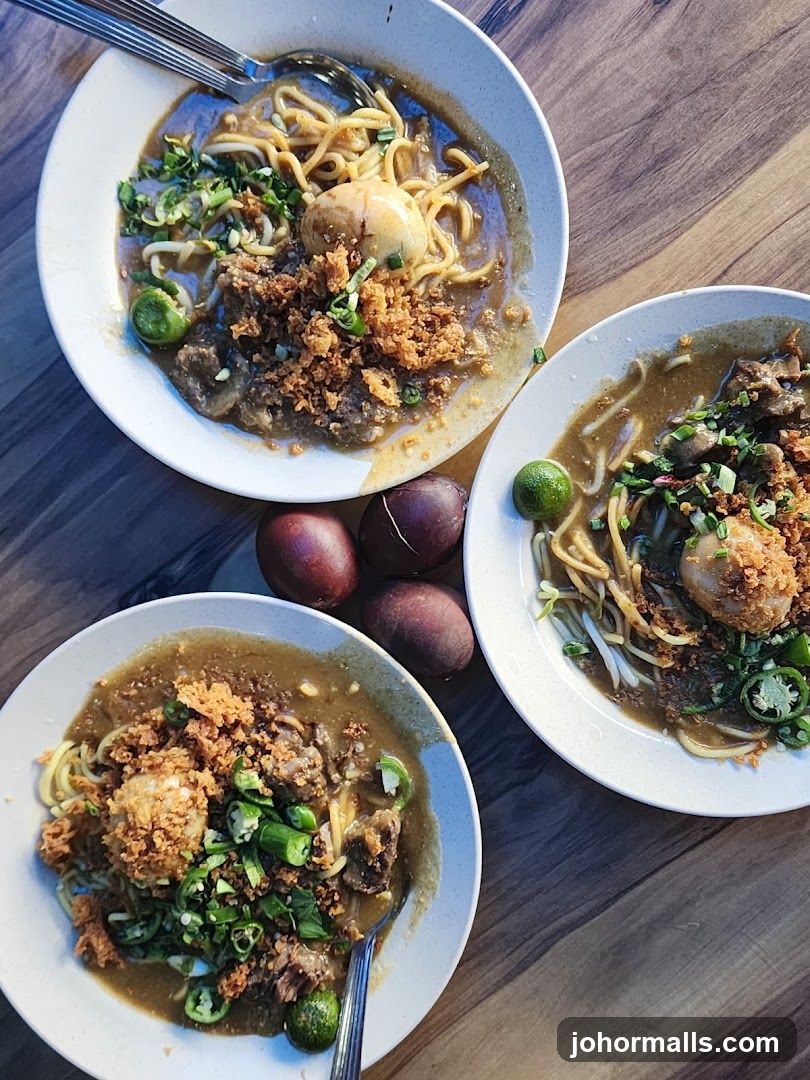 Three bowls of noodles with meat and egg