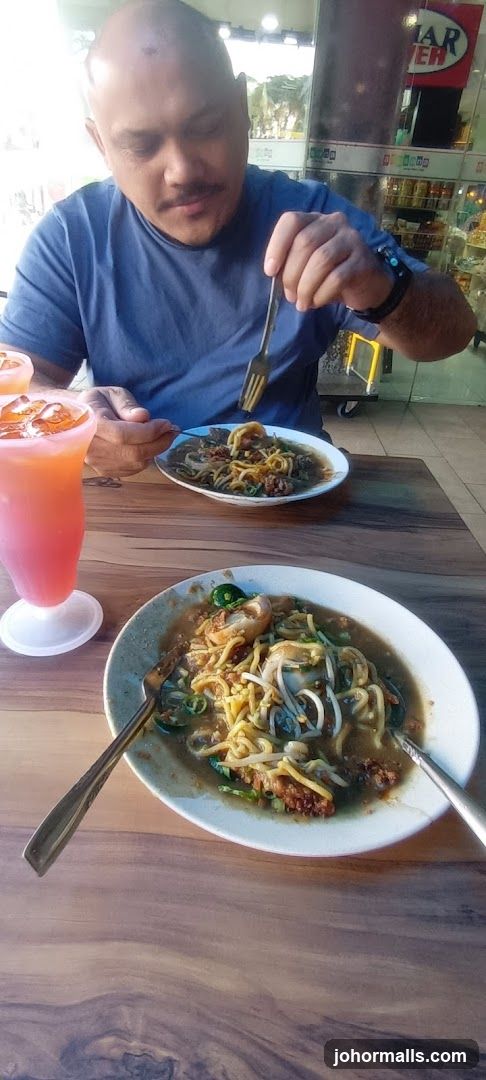 Man eating noodles at a restaurant