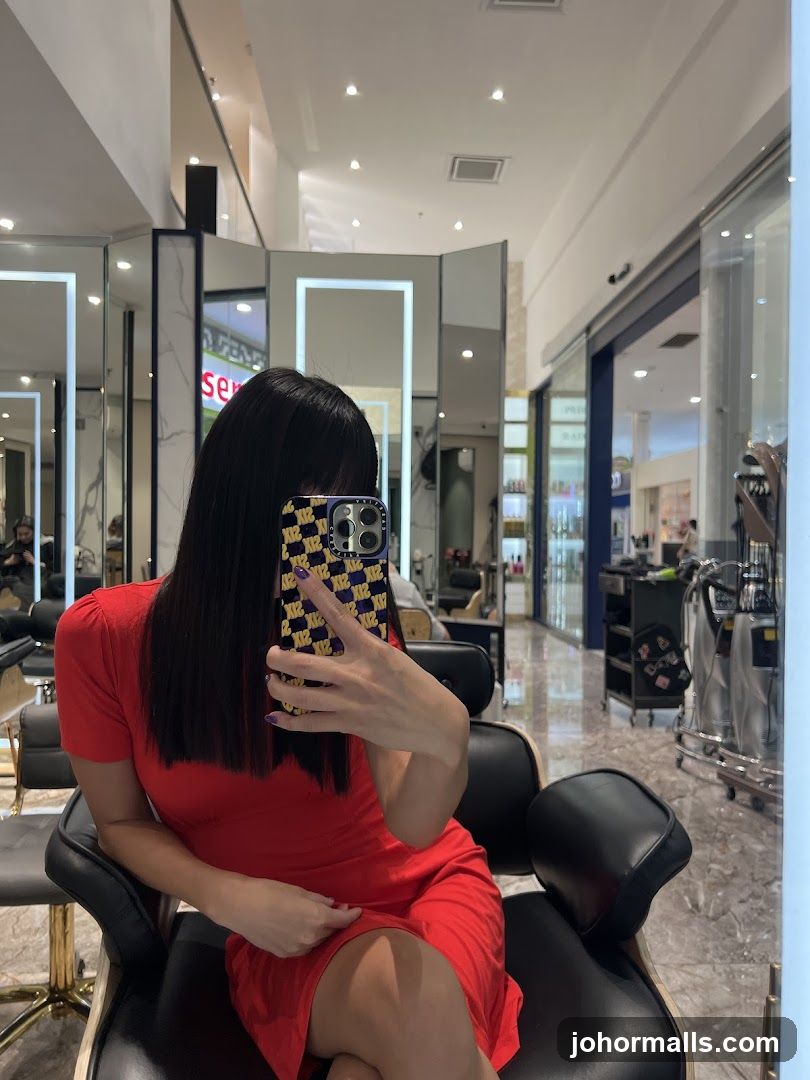 Woman in Red Dress Taking Selfie in Salon