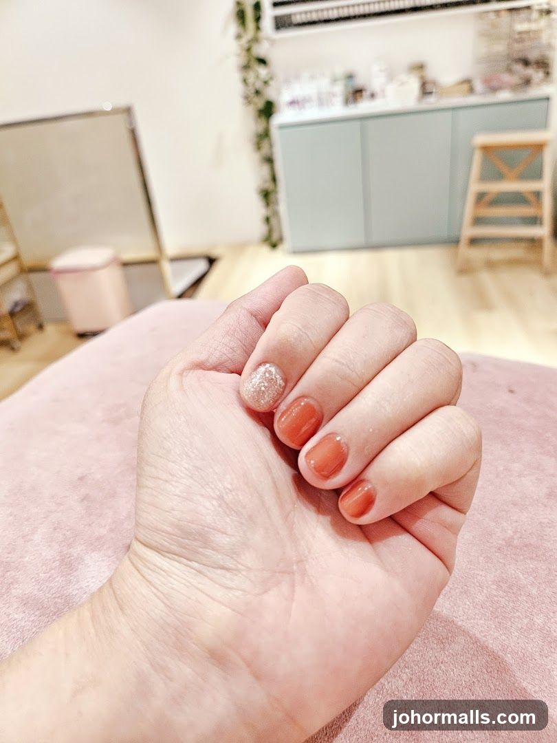 Woman's Hand with Orange Nails