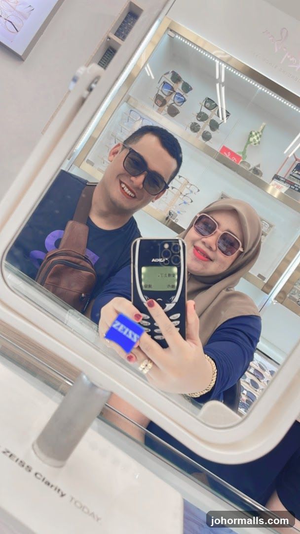 Couple taking a mirror selfie in an optical shop