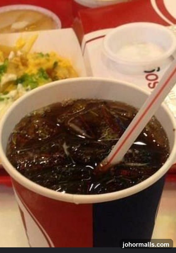 Soft drink with ice and straw