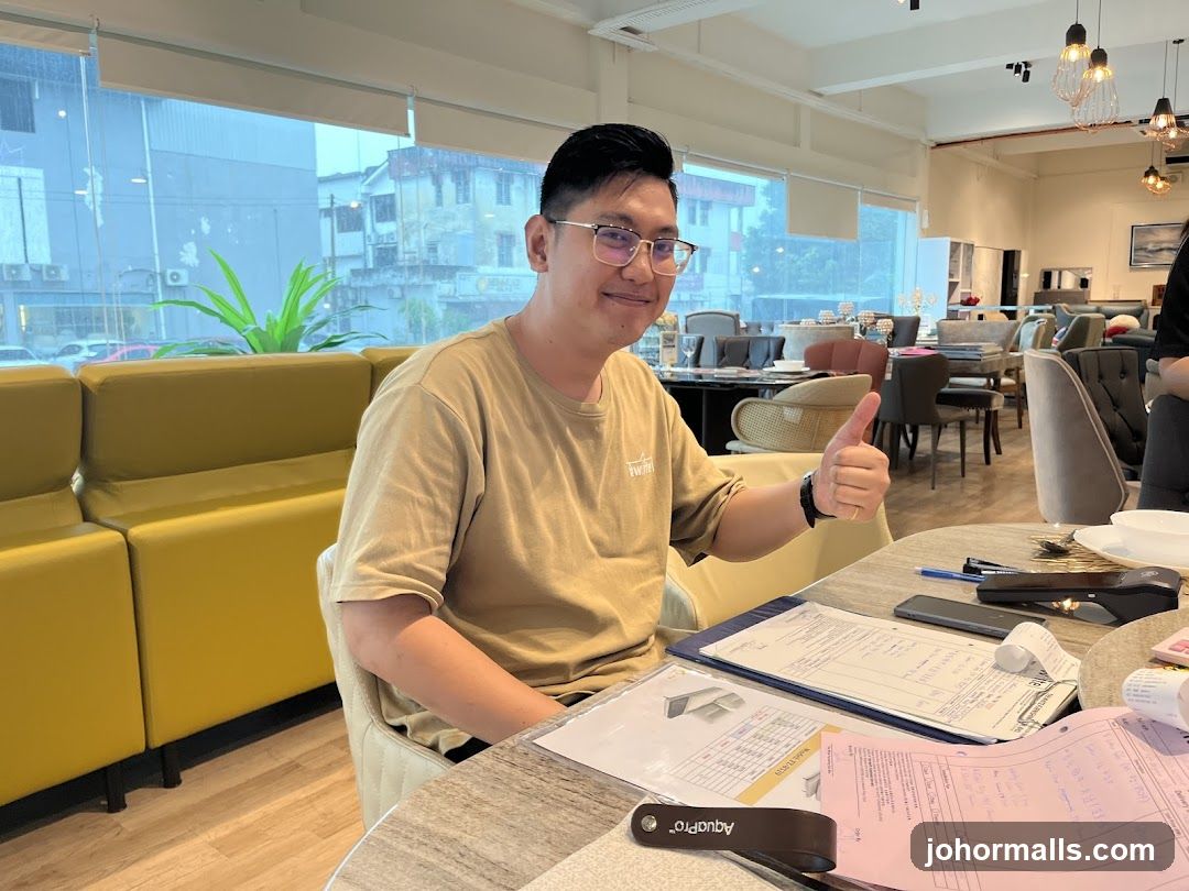 Man giving a thumbs up in a furniture store