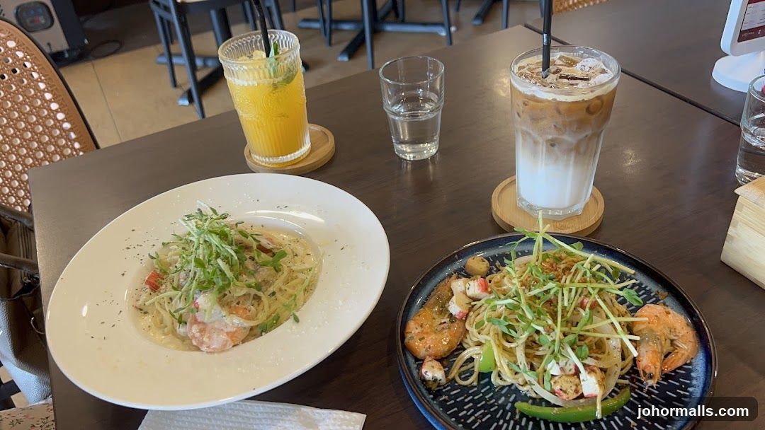 Two pasta dishes and drinks on a table