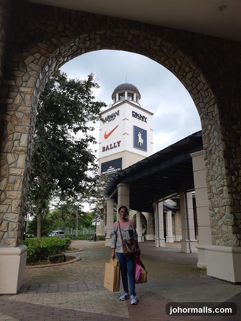 Woman with shopping bags at an outlet mall