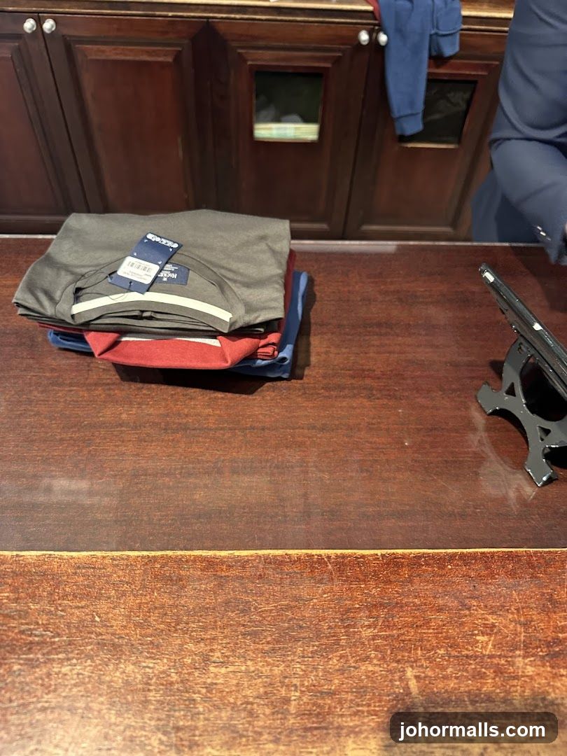 Folded T-shirts on a wooden counter