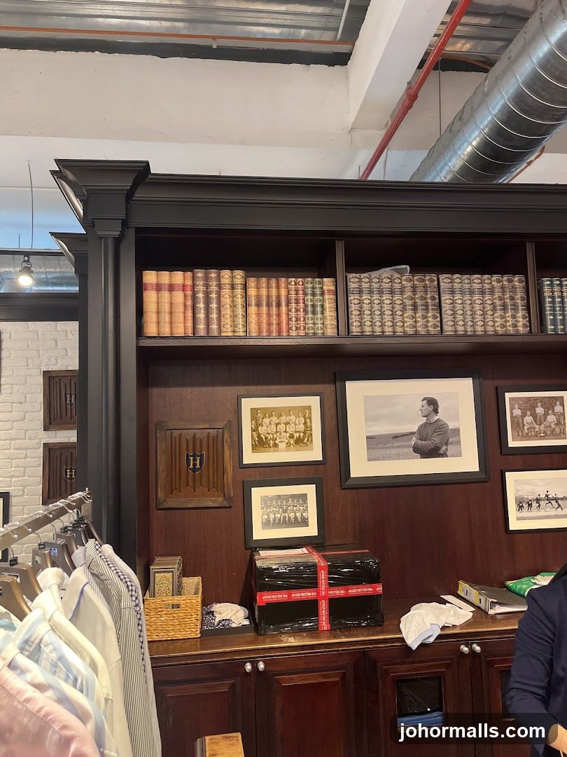 Bookshelf display with framed photos and clothing racks