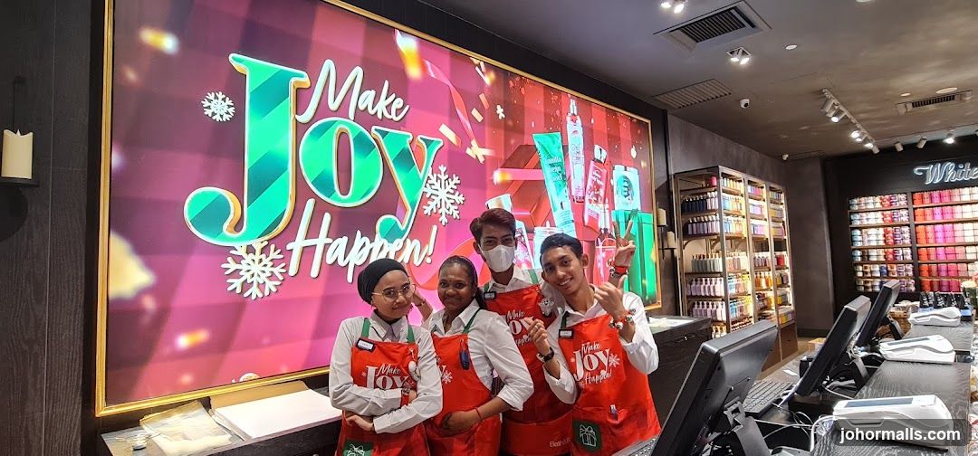 Store Employees Posing in Front of Holiday Display