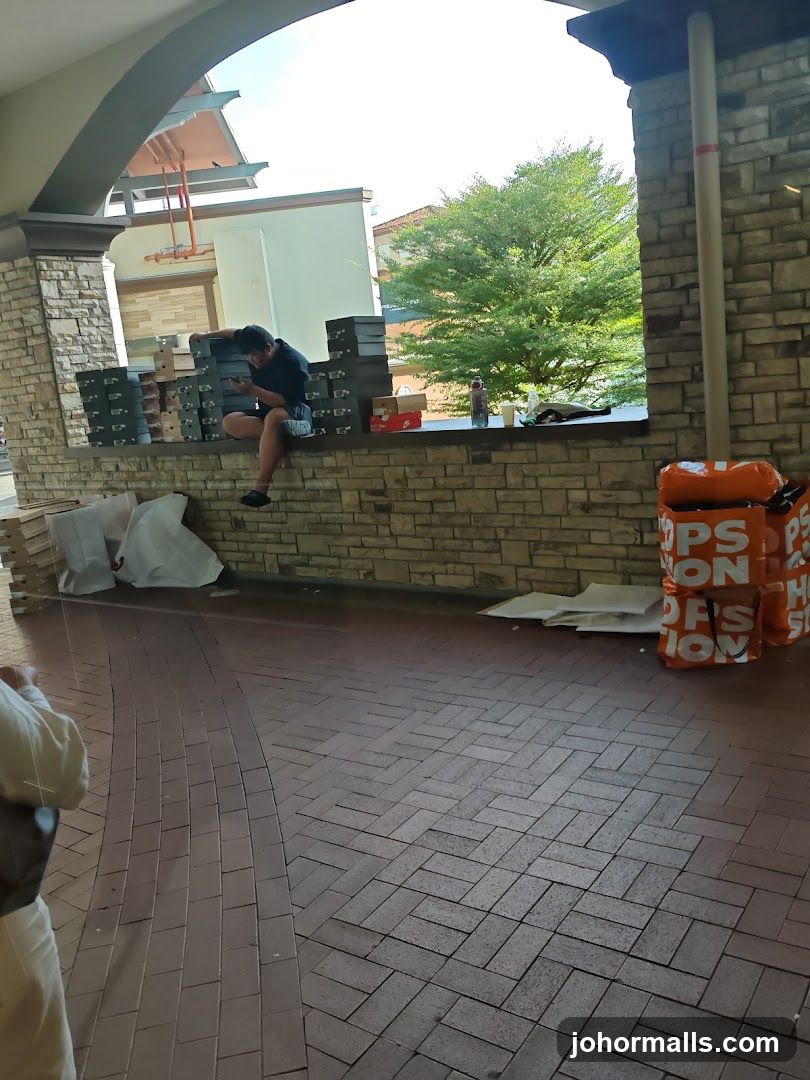 Man sitting with shoe boxes