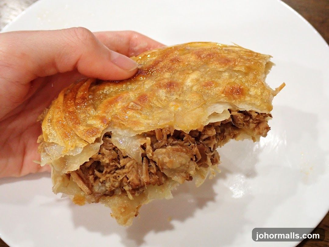 Hand holding a savory pastry
