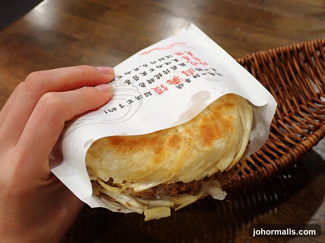 Hand holding a savory pastry