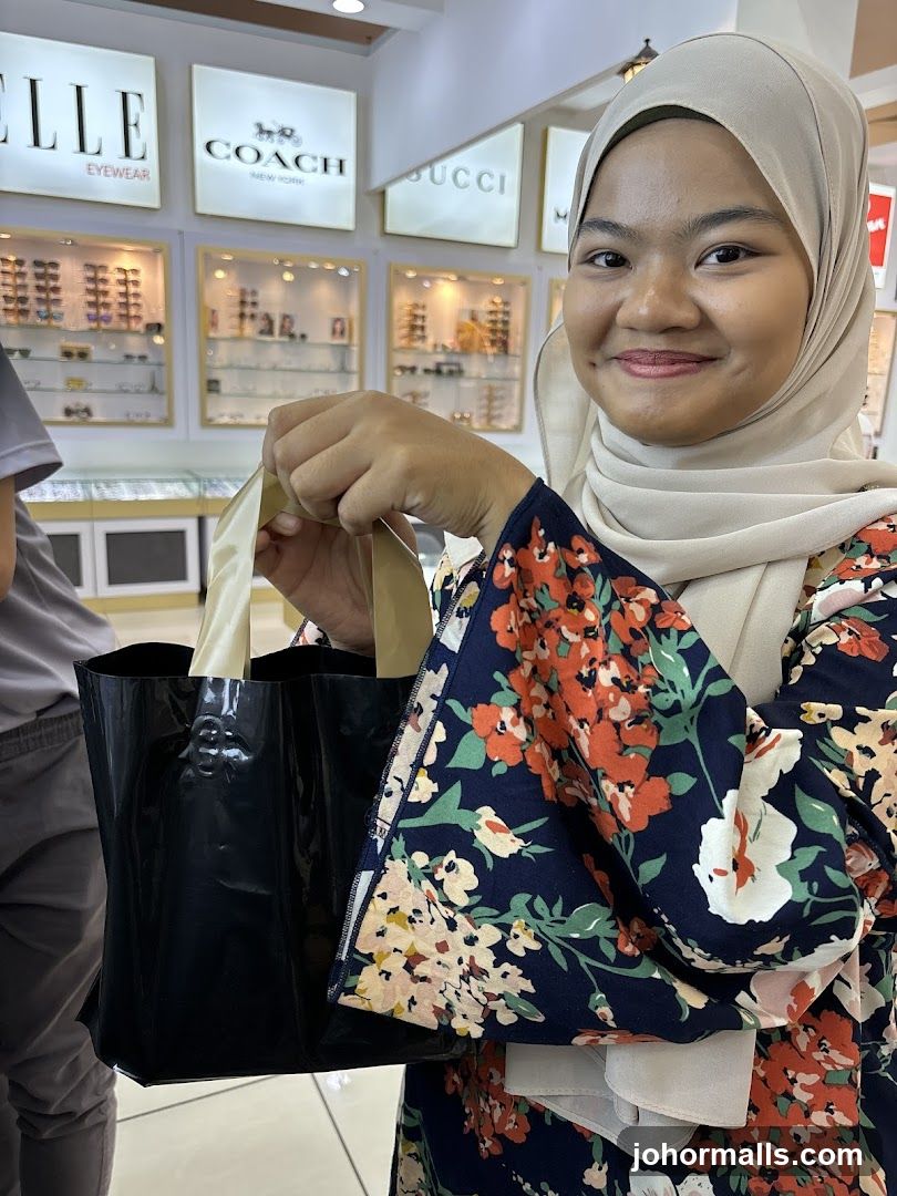 Woman holding a shopping bag in an optical store