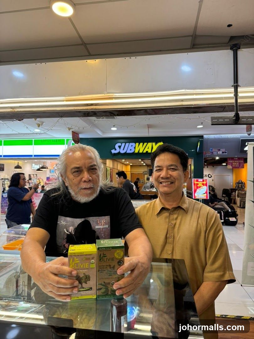 Two men holding boxes of olive oil