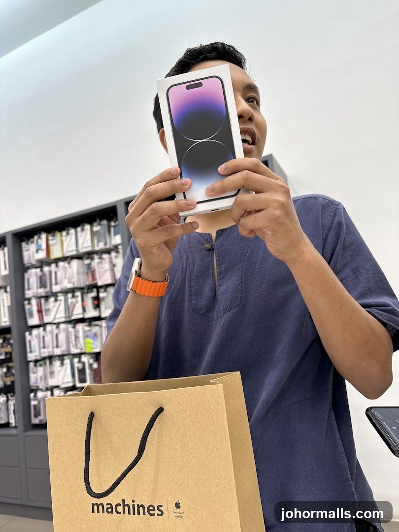 Man holding an iPhone box