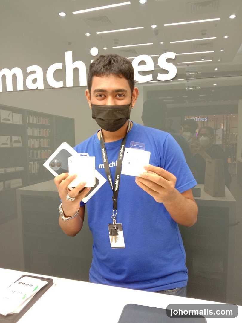 Salesperson holding Apple products