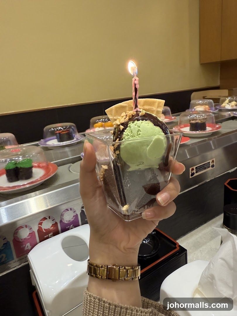 Dessert with Birthday Candle on Conveyor Belt