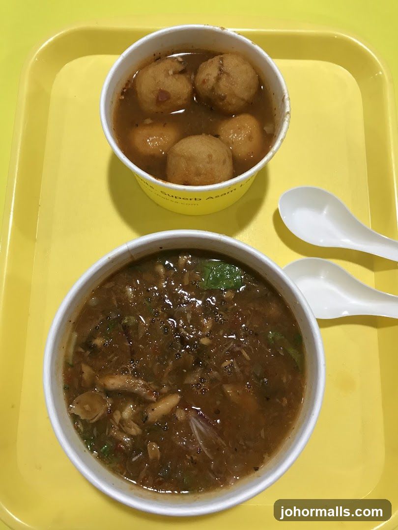Two Bowls of Soup with Spoons