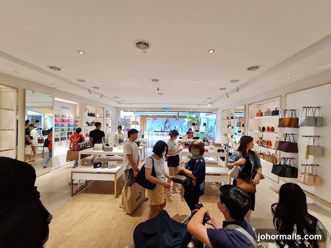 Customers browsing handbags in a store