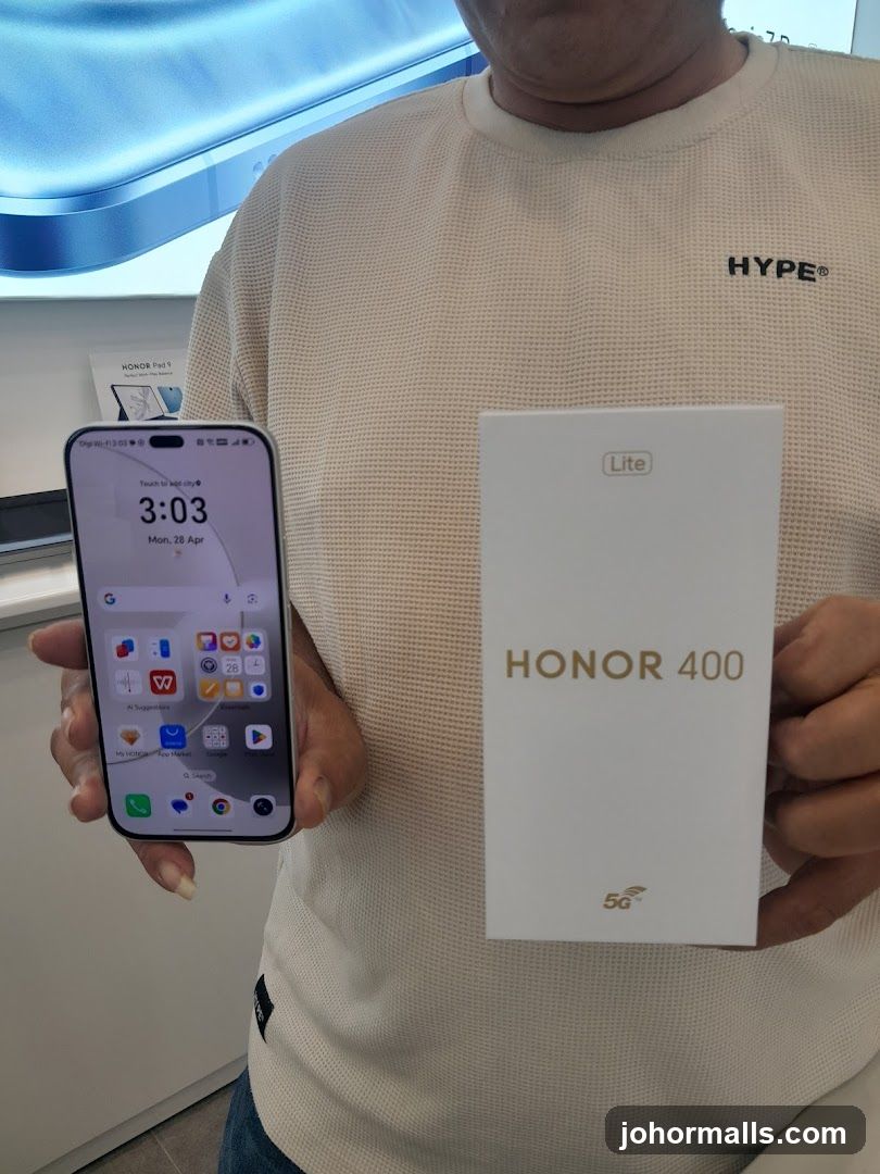 Person holding a smartphone and a box