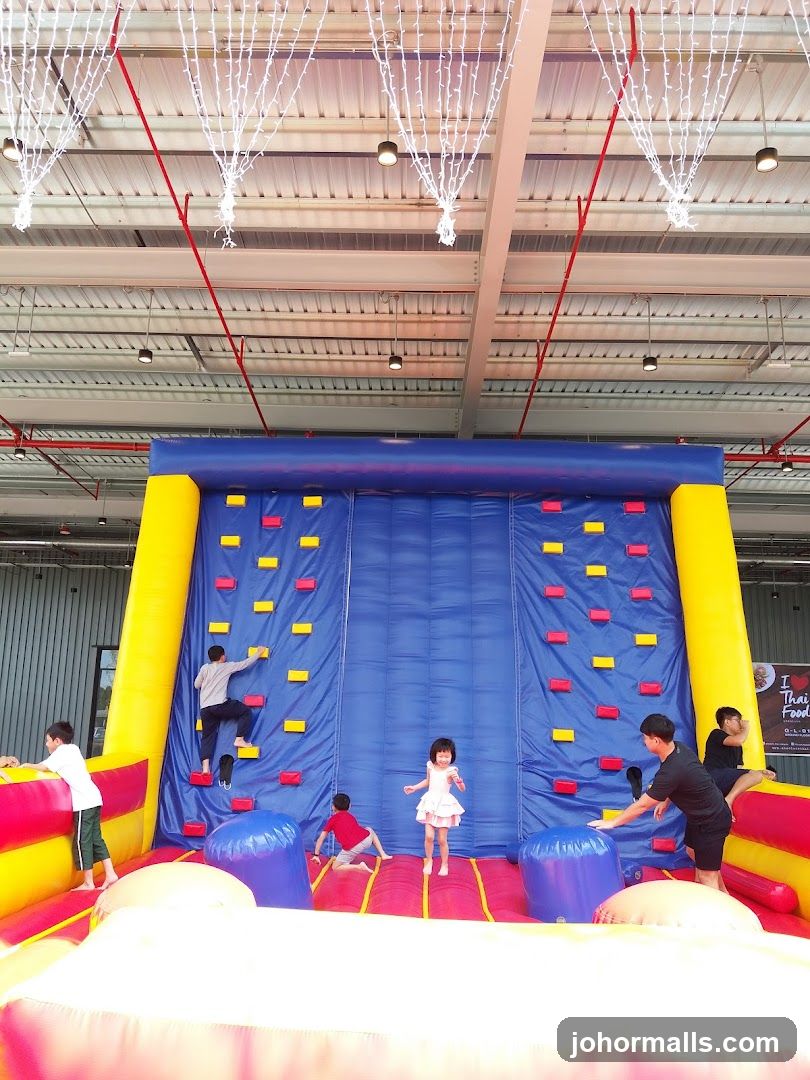 Children on inflatable climbing wall