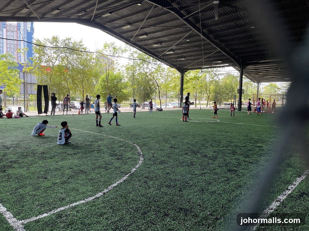 Children playing soccer on an indoor field