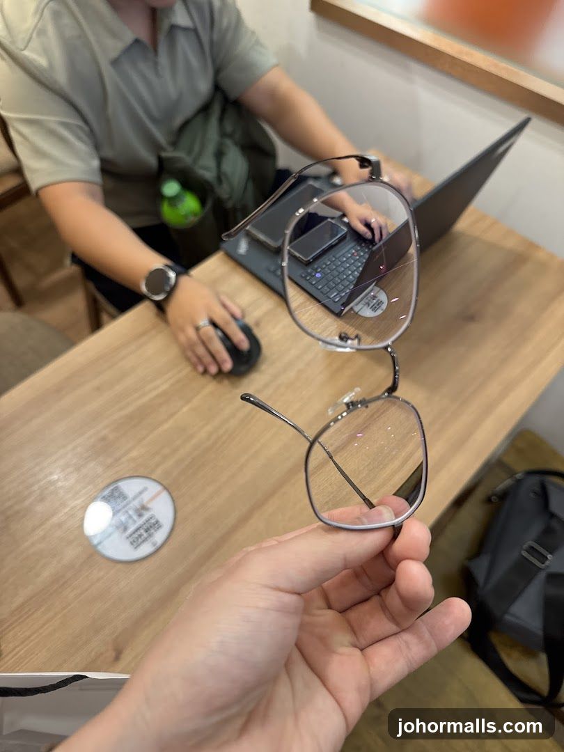 Person working on laptop with glasses