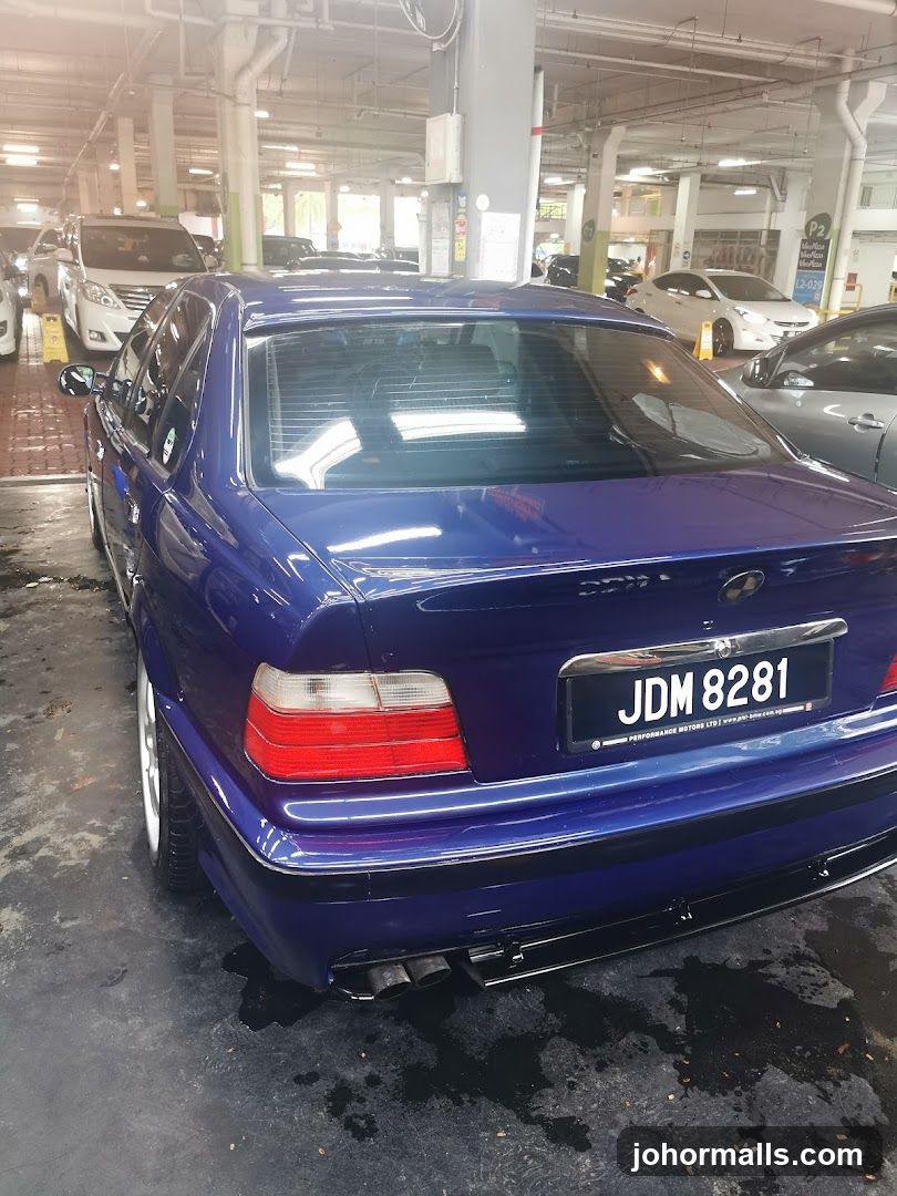 Blue Sedan in Parking Garage