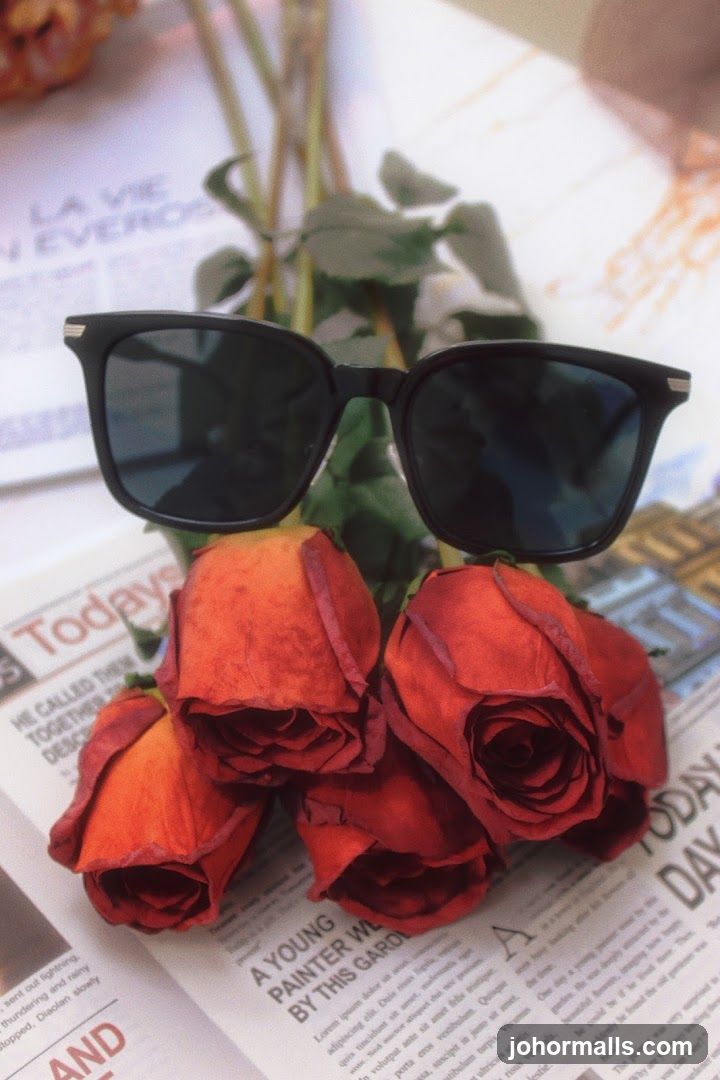 Sunglasses and Roses on Newspaper