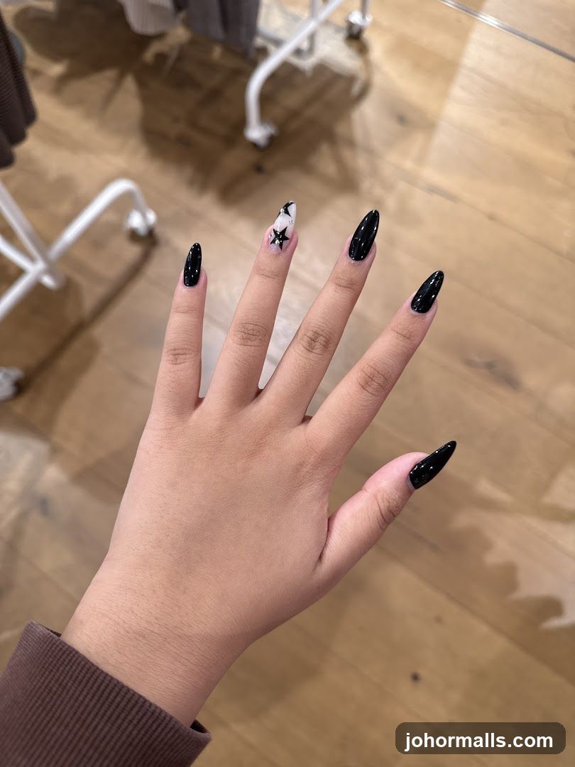 Black Stiletto Nails with Star Accent