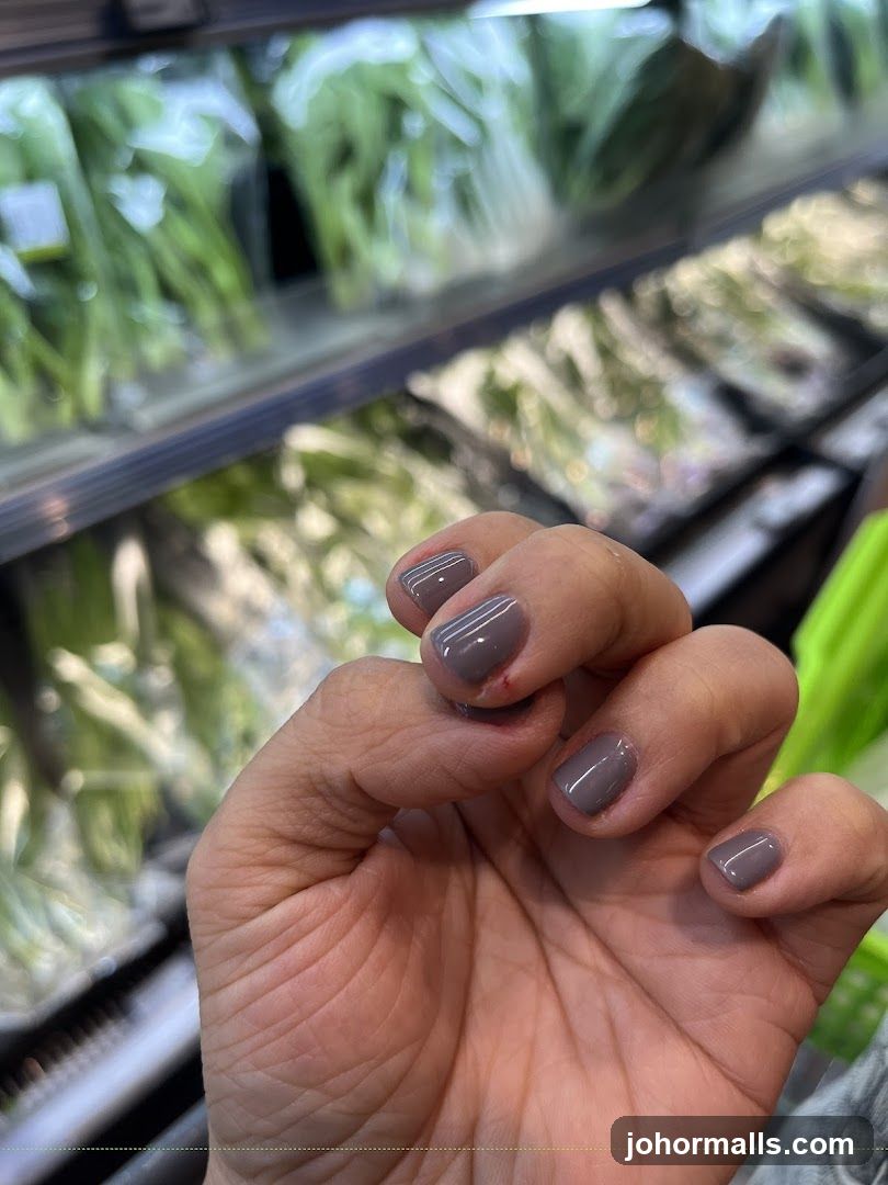 Hand with Gray Nail Polish in Grocery Store