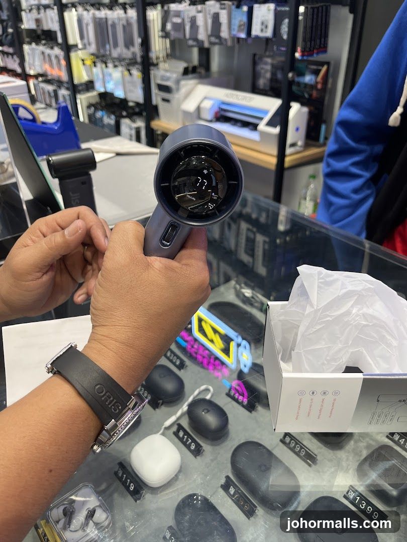 Person holding a portable fan in a store