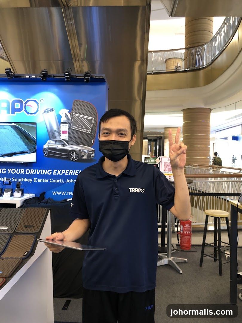 Man holding a tablet at a TRAPO display