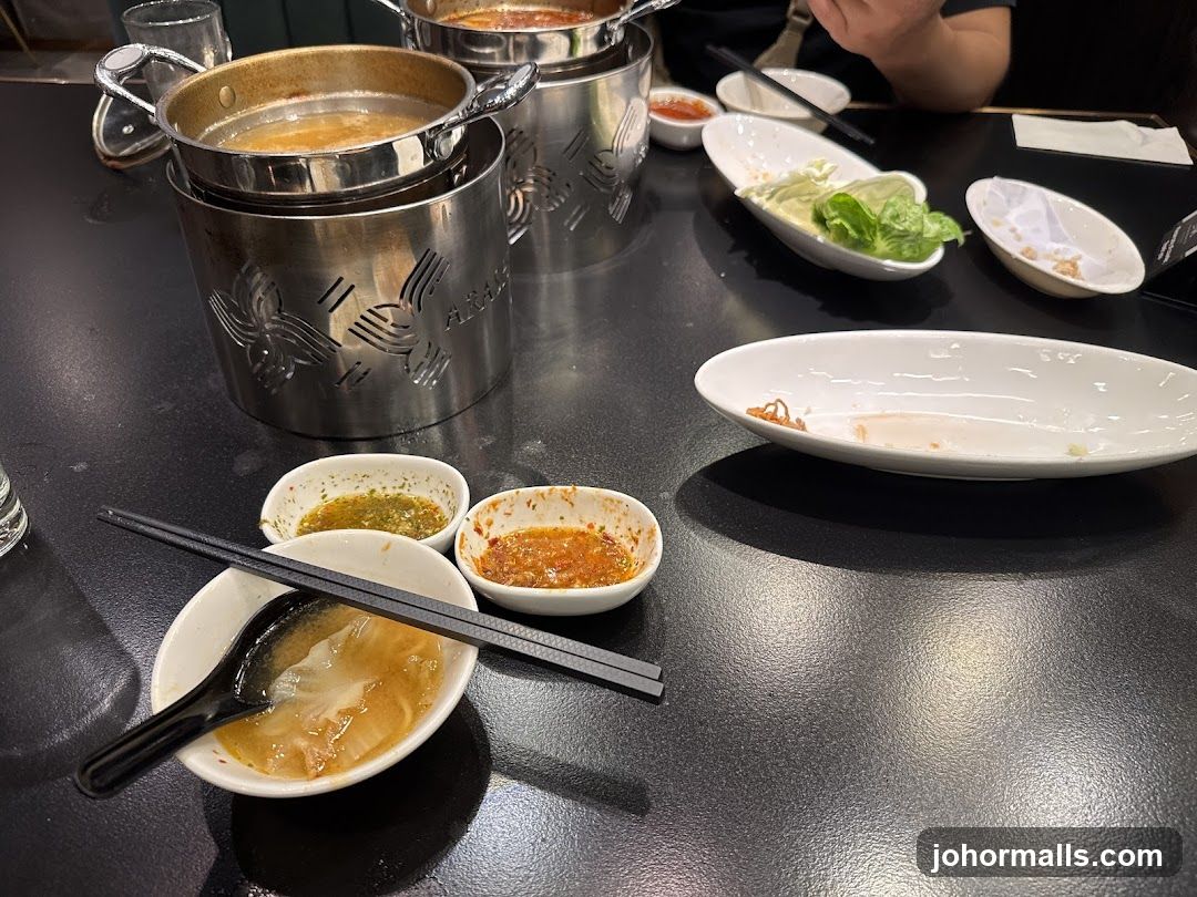 Table with Hot Pot and Dipping Sauces