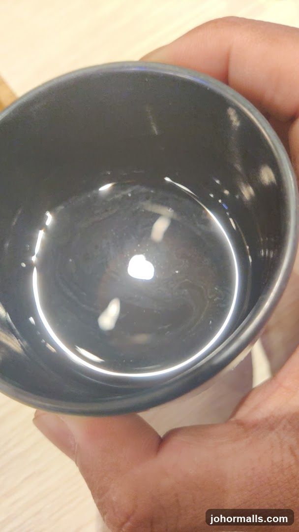 Hand holding a cup