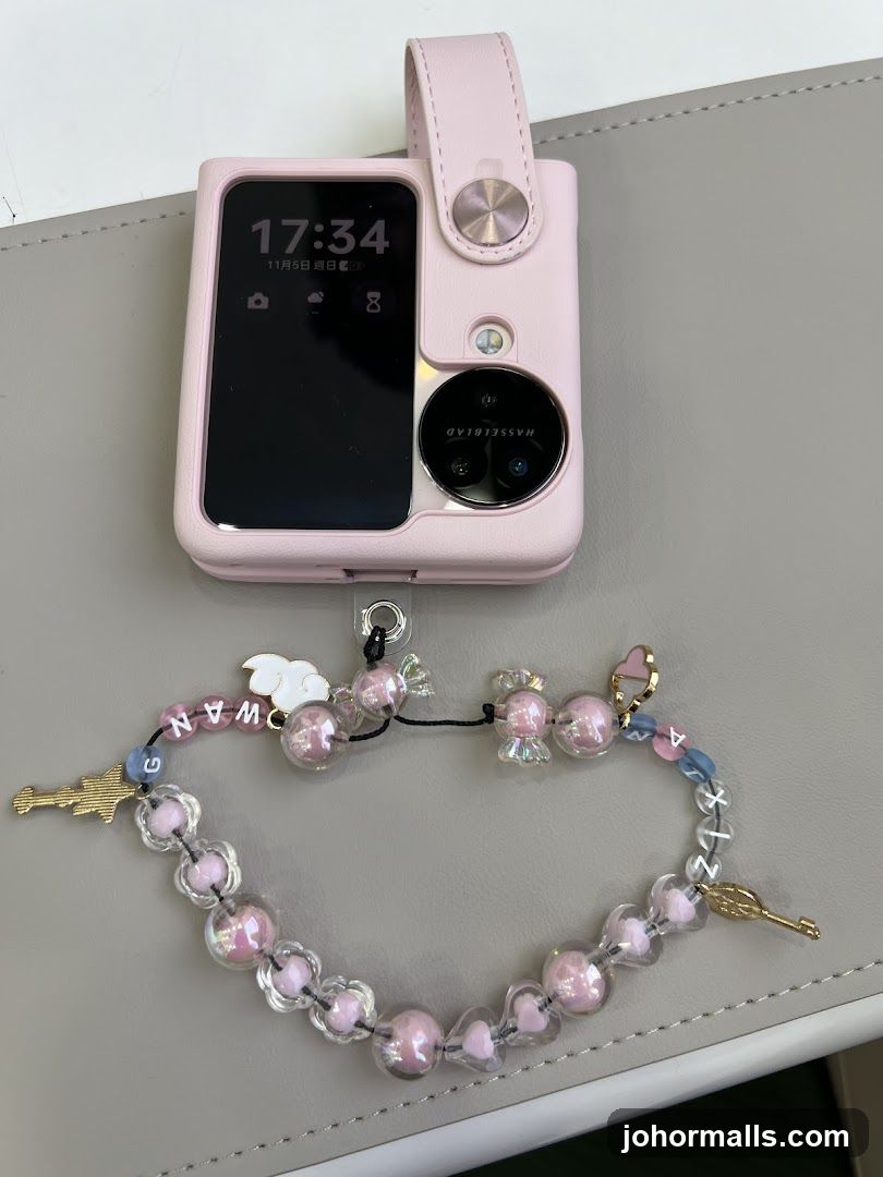 Pink smartphone with decorative strap