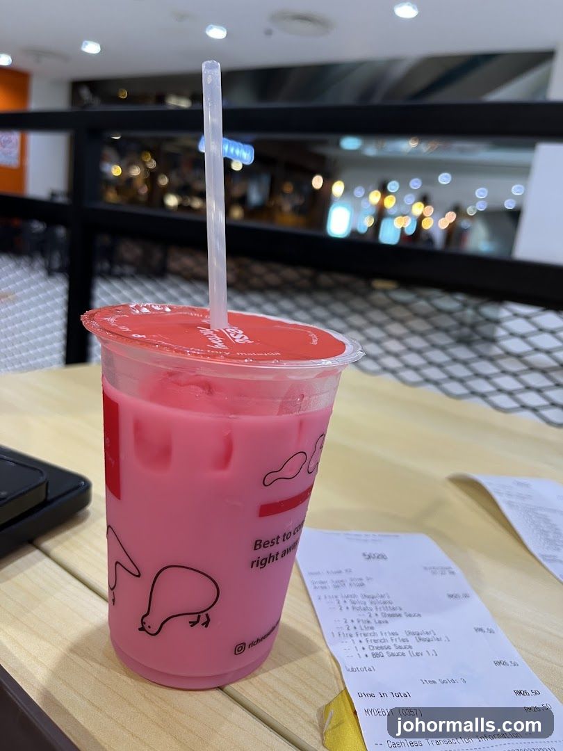 Pink beverage with receipt on table