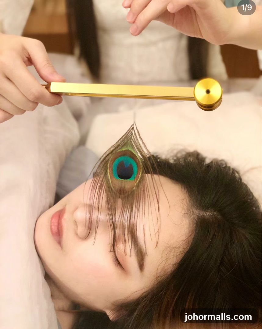 Person receiving treatment with peacock feather and golden tool