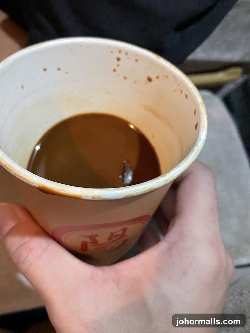 Hand holding a coffee cup