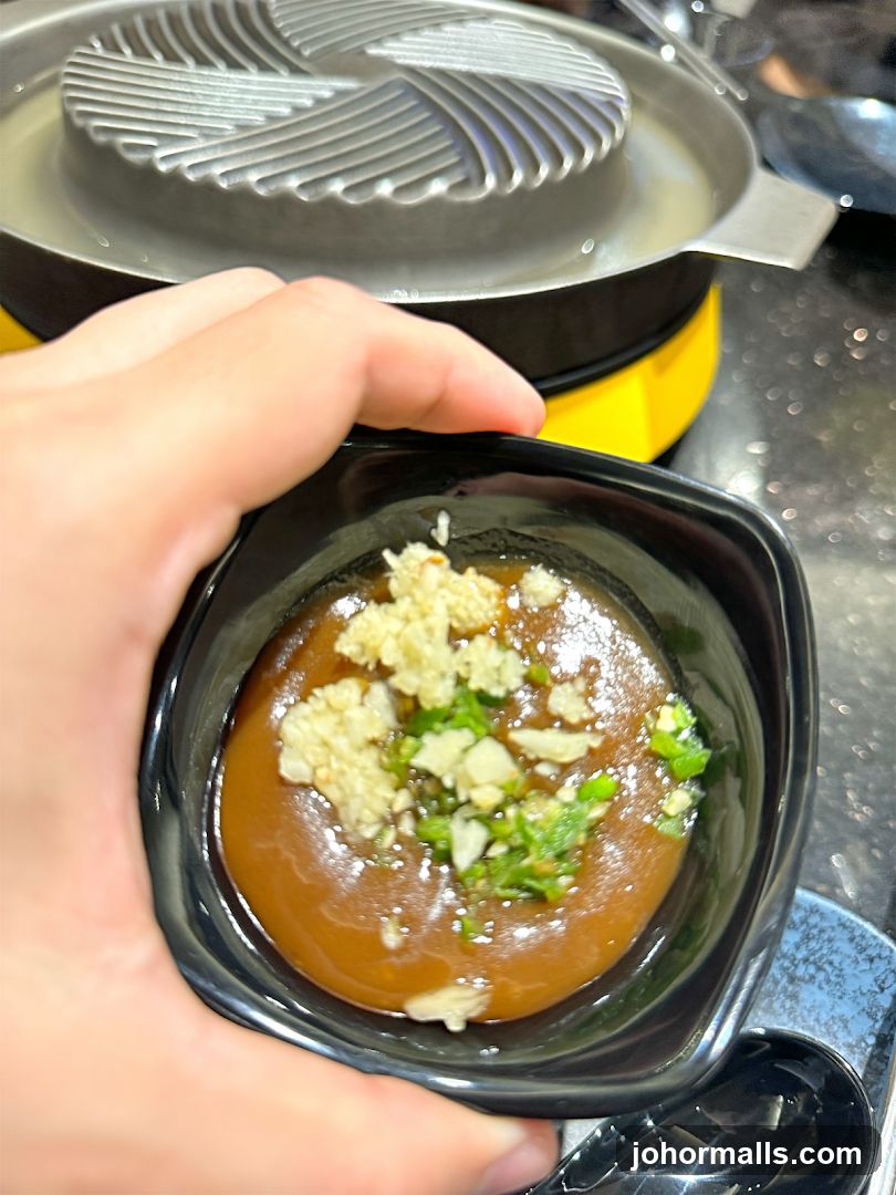 Hand holding dipping sauce
