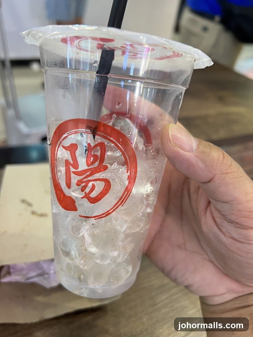 Hand holding iced drink cup