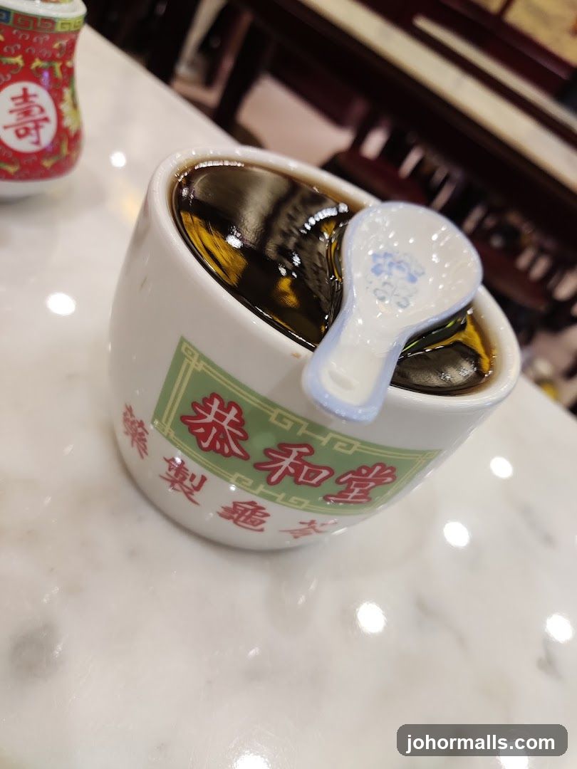 Cup of dark liquid with spoon